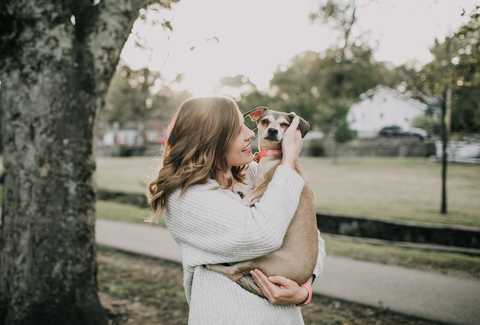 Owner hugging her dog in a park